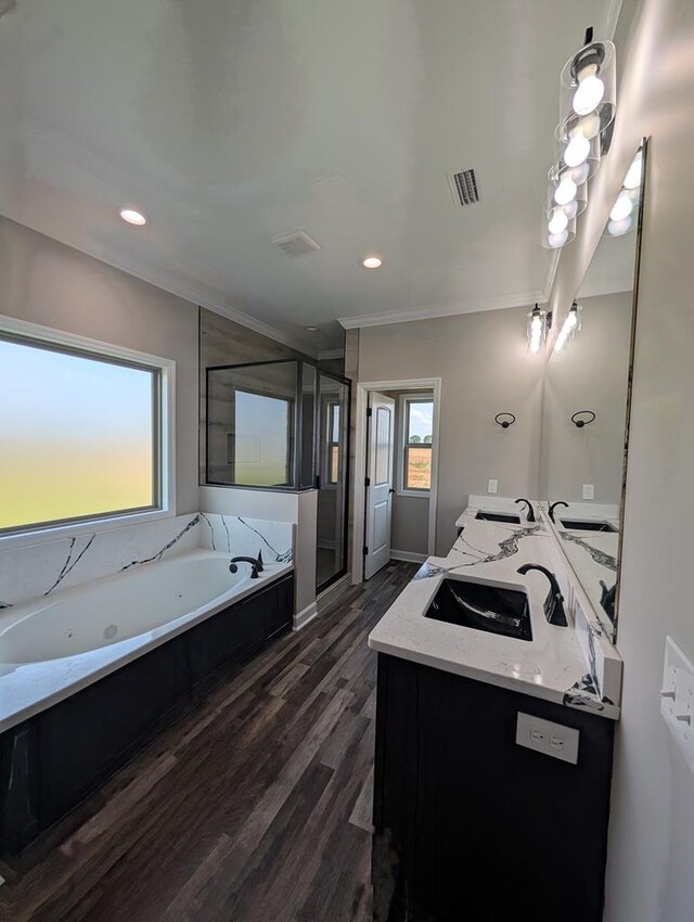 12611 Fortner St, Newton, AL 36352 - full bathroom with ornamental molding, double vanity, a tub with jets, wood finished floors, and a stall shower