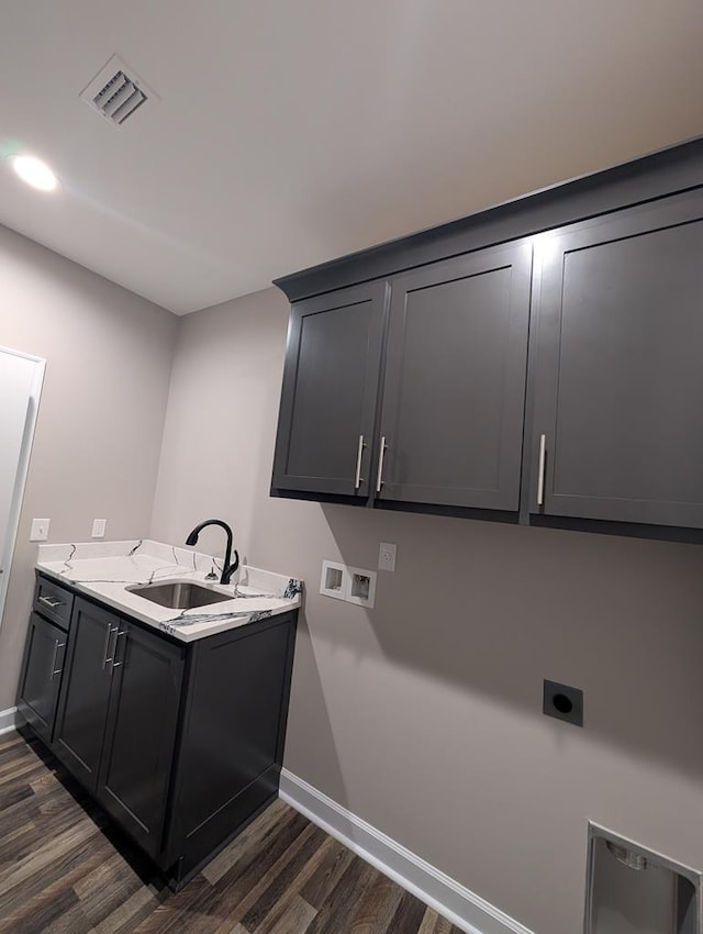 12611 Fortner St, Newton, AL 36352 - laundry room featuring dark wood-type flooring, hookup for an electric dryer, cabinet space, baseboards, and washer hookup