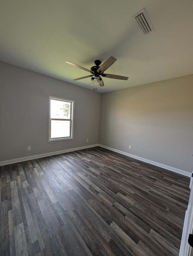 12611 Fortner St, Newton, AL 36352 - spare room featuring dark wood-type flooring, baseboards, and ceiling fan