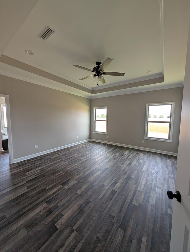 12611 Fortner St, Newton, AL 36352 - spare room featuring a raised ceiling, ornamental molding, baseboards, dark wood-type flooring, and a ceiling fan