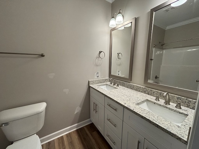 full bathroom with bathtub / shower combination, toilet, ornamental molding, vanity, and hardwood / wood-style floors