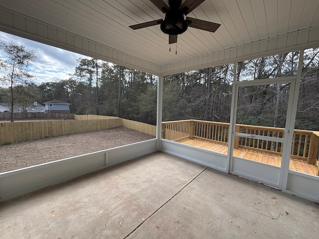 unfurnished sunroom with ceiling fan