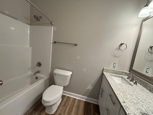 full bathroom with hardwood / wood-style flooring, vanity, bathtub / shower combination, and toilet