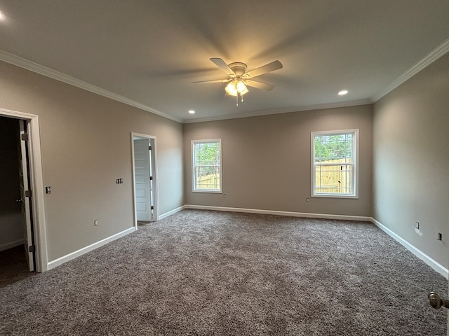 empty room featuring crown molding, ceiling fan, and carpet