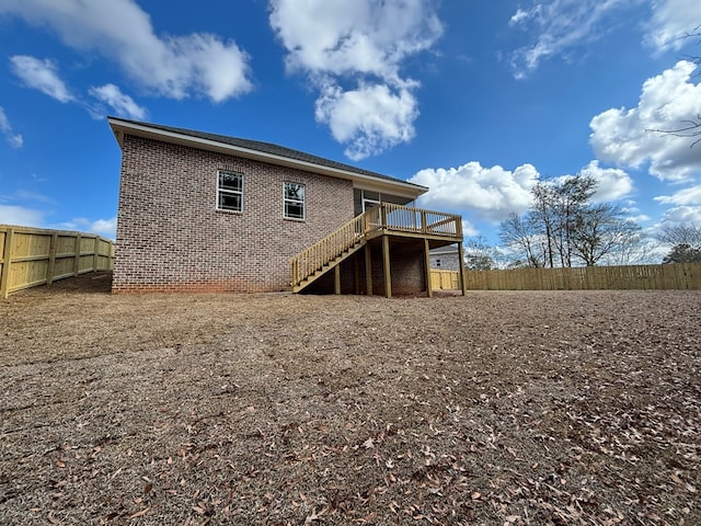 back of house with a wooden deck