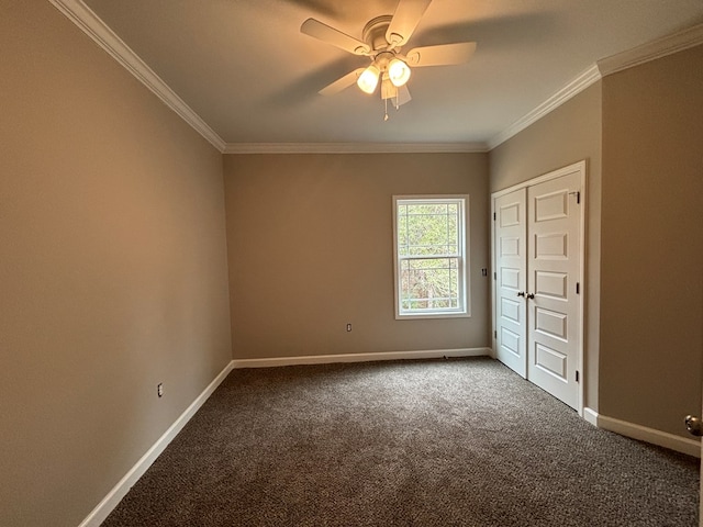 unfurnished room with crown molding, carpet, and ceiling fan