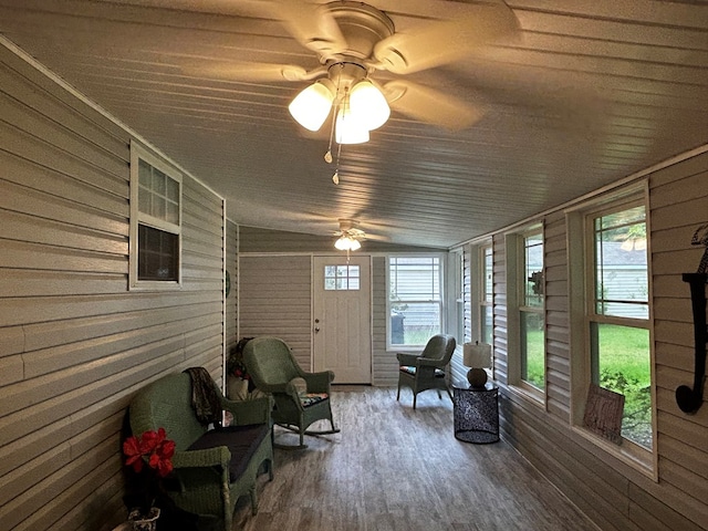 unfurnished sunroom with a ceiling fan