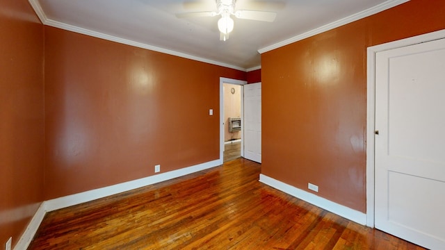 empty room with hardwood / wood-style flooring, ceiling fan, and ornamental molding