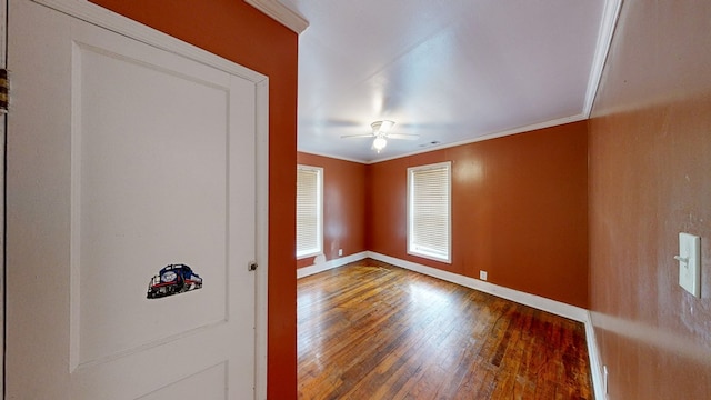 unfurnished room with crown molding, hardwood / wood-style flooring, and ceiling fan