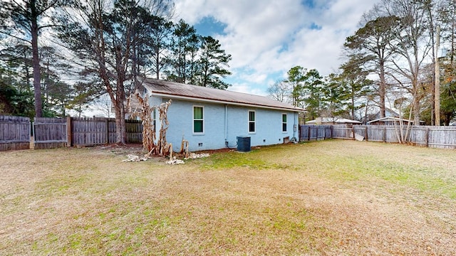 back of property with a yard and cooling unit