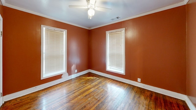 spare room with hardwood / wood-style flooring, ornamental molding, and ceiling fan