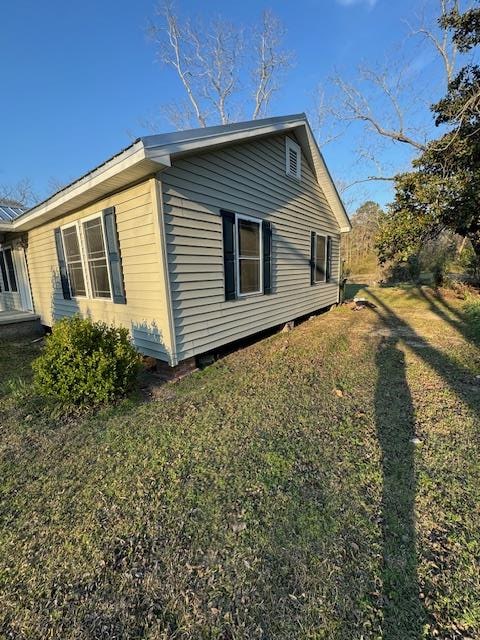 view of side of property with a lawn