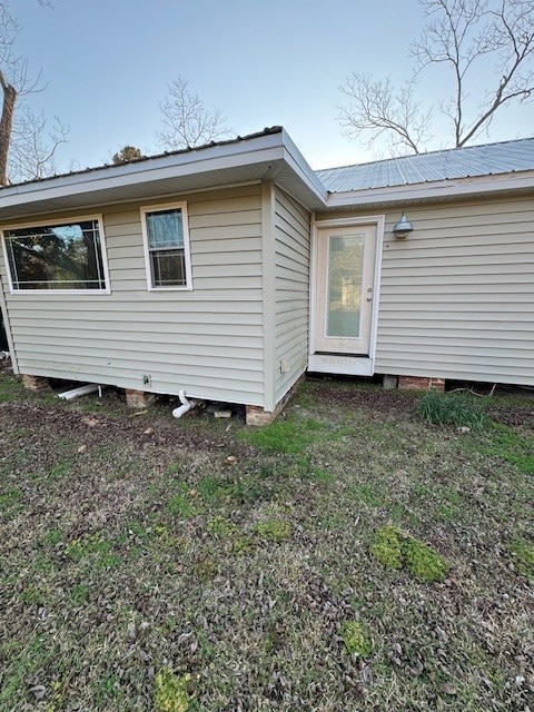 rear view of property featuring metal roof