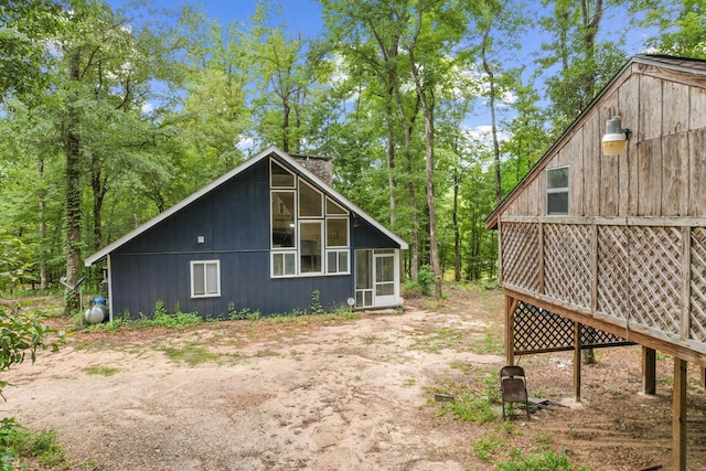 8165 County Road 97, Abbeville, AL 36310 - view of side of property featuring a sunroom and a chimney