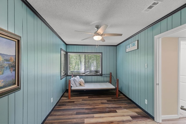 8165 County Road 97, Abbeville, AL 36310 - sitting room featuring wood finished floors, ceiling fan, crown molding, a textured ceiling, and baseboards