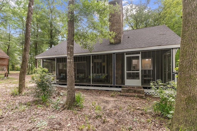 8165 County Road 97, Abbeville, AL 36310 - rear view of property with a sunroom, roof with shingles, and a chimney