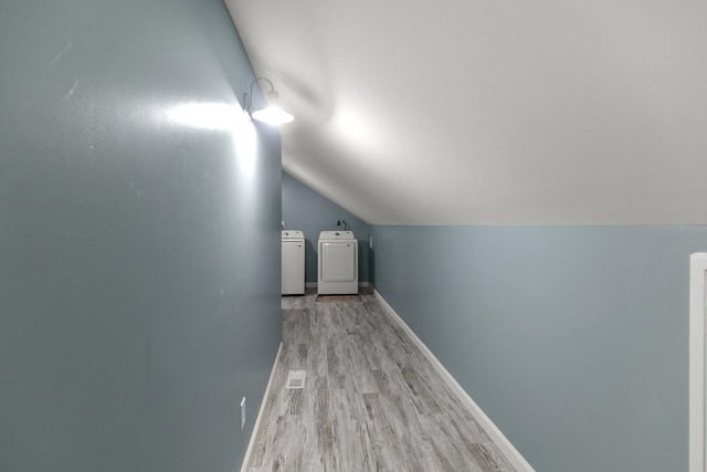 8165 County Road 97, Abbeville, AL 36310 - bonus room featuring separate washer and dryer, light wood-style floors, vaulted ceiling, and baseboards