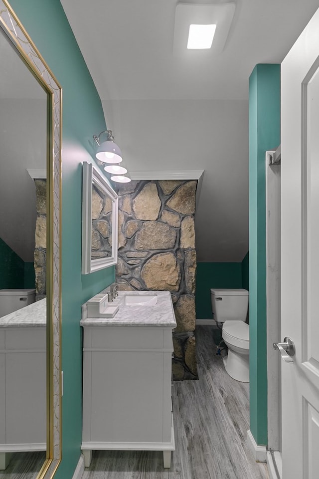 8165 County Road 97, Abbeville, AL 36310 - full bath featuring wood finished floors, vanity, toilet, and baseboards