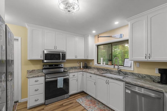 8165 County Road 97, Abbeville, AL 36310 - kitchen featuring stainless steel appliances, a sink, light wood-style floors, white cabinets, and recessed lighting