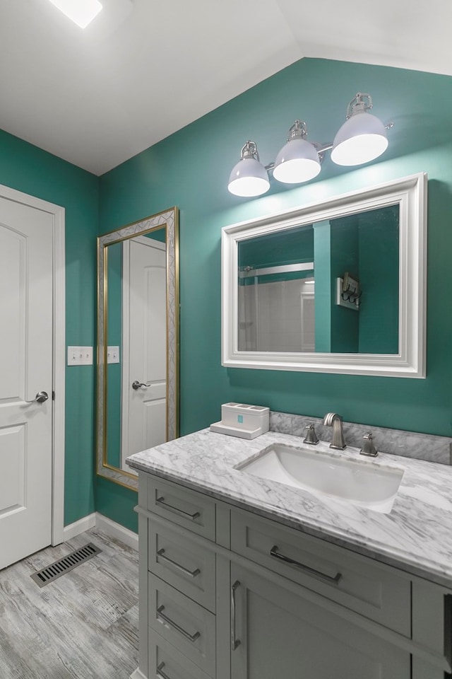 8165 County Road 97, Abbeville, AL 36310 - bathroom featuring vanity, wood finished floors, a shower, and baseboards