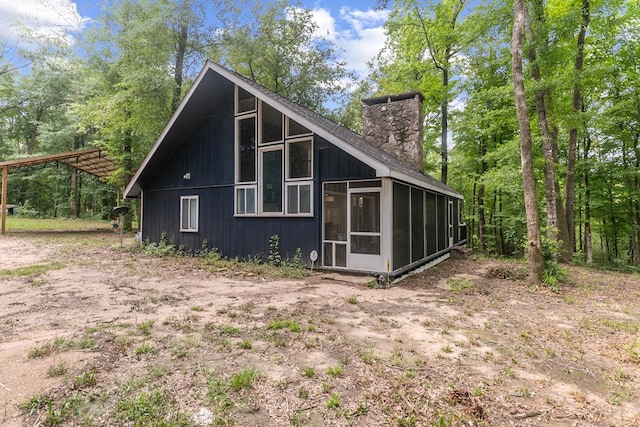 8165 County Road 97, Abbeville, AL 36310 - view of side of property featuring a sunroom and a chimney