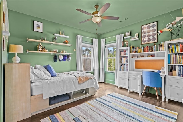 bedroom featuring visible vents, wood finished floors, and a ceiling fan