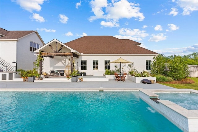 back of house featuring fence, ceiling fan, a fenced in pool, an in ground hot tub, and a patio area