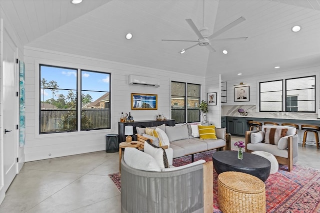 living area with lofted ceiling, a ceiling fan, a wall mounted AC, and recessed lighting