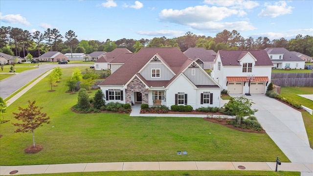 view of front of home featuring a residential view, concrete driveway, a garage, and a front yard
