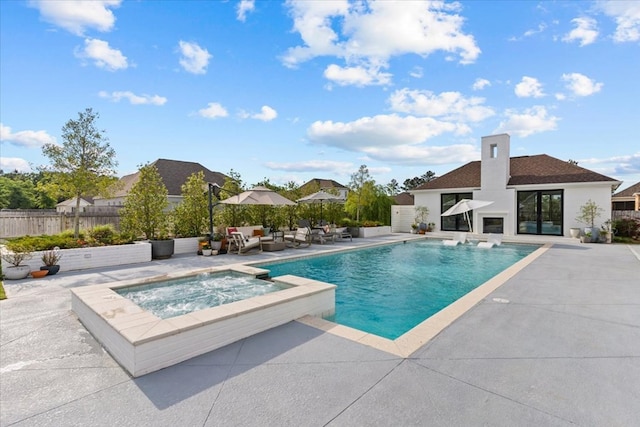 view of swimming pool with a patio, an outdoor hangout area, a pool with connected hot tub, and fence