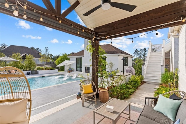 view of pool with a patio, a fenced in pool, ceiling fan, stairs, and fence