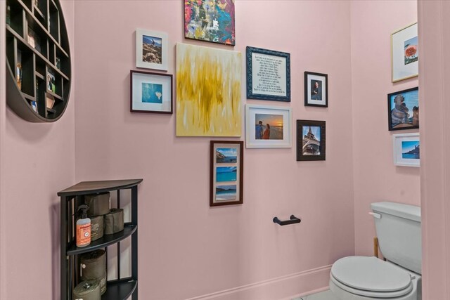 bathroom with toilet and baseboards