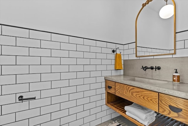 bathroom featuring tile walls, tasteful backsplash, a tile shower, and vanity
