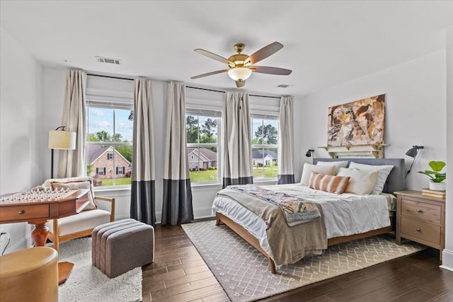 bedroom featuring baseboards, visible vents, a ceiling fan, and dark wood-type flooring