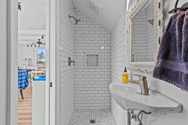 bathroom featuring tile patterned floors, a shower stall, ceiling fan, a sink, and lofted ceiling