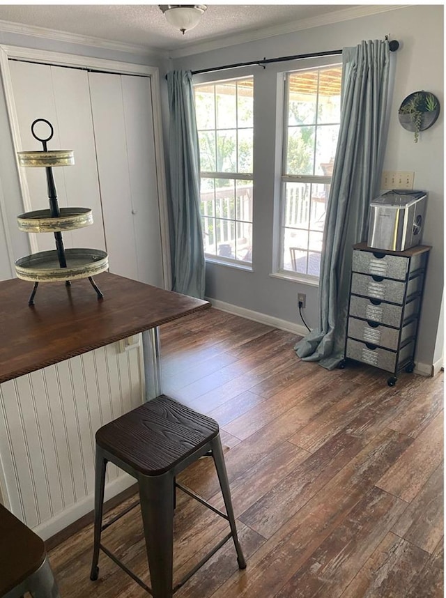 dining area featuring hardwood / wood-style floors, radiator heating unit, baseboards, and a wealth of natural light