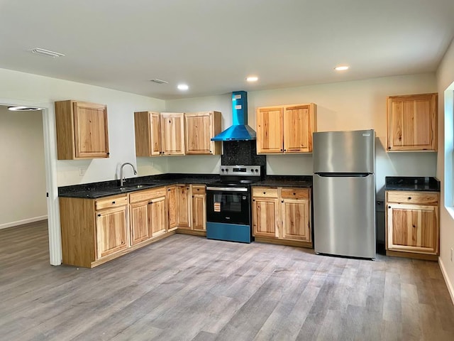 601 Melody Ln, Dothan, AL 36301 - kitchen featuring appliances with stainless steel finishes, wall chimney range hood, a sink, light wood finished floors, and baseboards