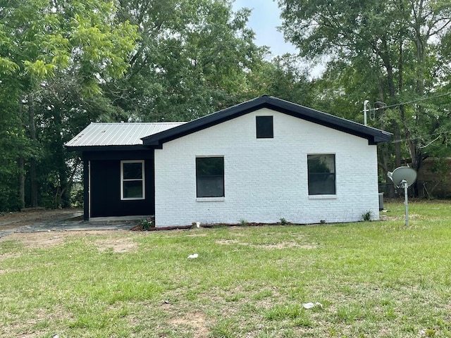 601 Melody Ln, Dothan, AL 36301 - view of property exterior featuring a yard, metal roof, and view of wooded area