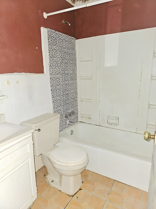 228 Sharon Ln, Ozark, AL 36360 - bathroom featuring shower / bathtub combination, tile patterned flooring, tile walls, and vanity