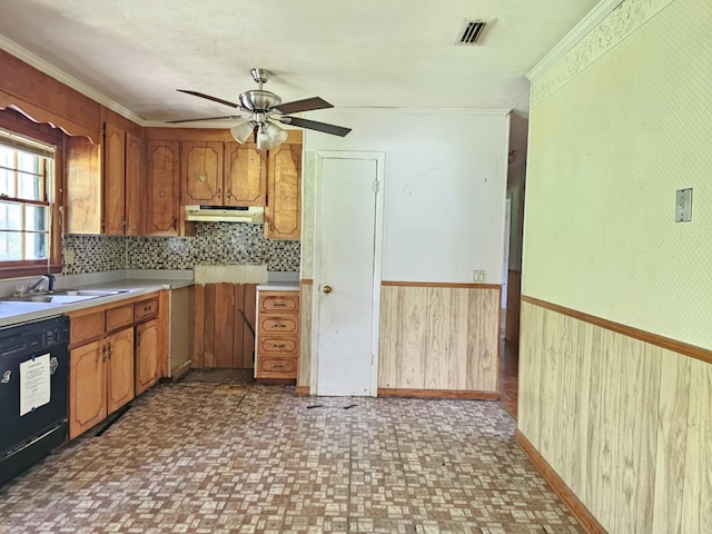 228 Sharon Ln, Ozark, AL 36360 - kitchen featuring black dishwasher, crown molding, ceiling fan, under cabinet range hood, and brown cabinetry