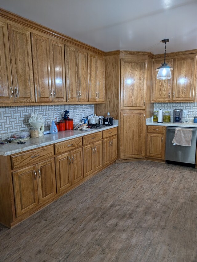 2302 Stonebridge Rd, Dothan, AL 36301 - kitchen with stainless steel dishwasher, brown cabinetry, backsplash, and light countertops
