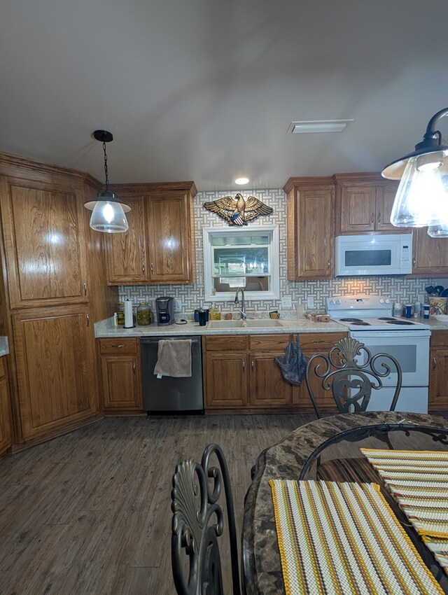 2302 Stonebridge Rd, Dothan, AL 36301 - kitchen with white appliances, a sink, brown cabinetry, and tasteful backsplash
