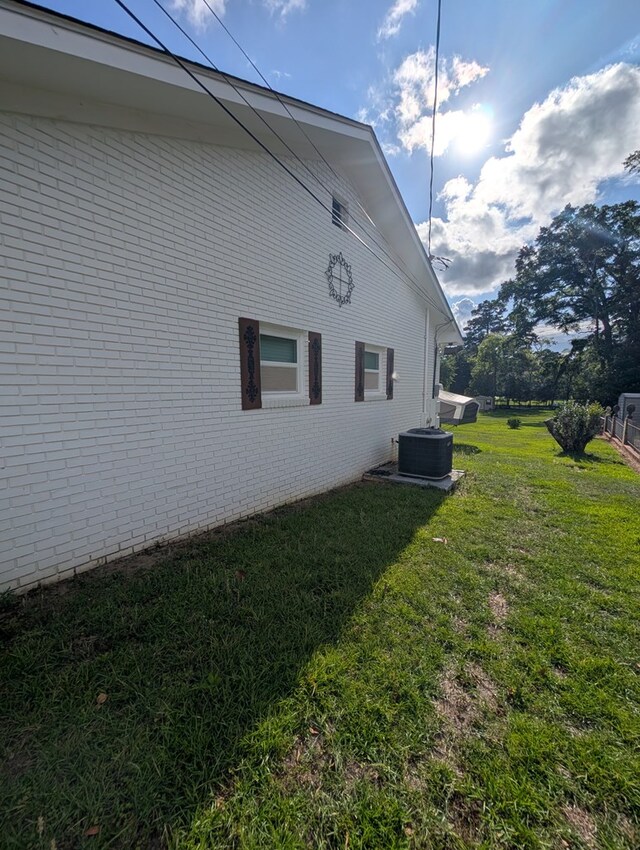 2302 Stonebridge Rd, Dothan, AL 36301 - view of side of property with a yard, brick siding, and central air condition unit
