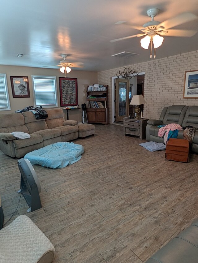 2302 Stonebridge Rd, Dothan, AL 36301 - living area with ceiling fan, wood finished floors, and brick wall