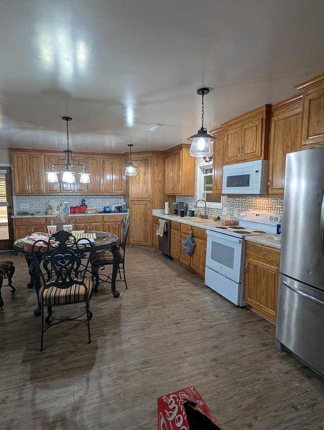 2302 Stonebridge Rd, Dothan, AL 36301 - kitchen featuring white appliances, a sink, tasteful backsplash, light countertops, and brown cabinetry