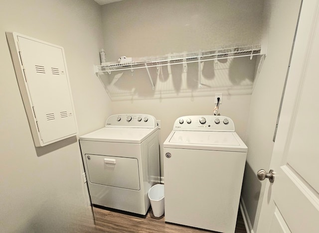 laundry room featuring hardwood / wood-style floors and washer and dryer