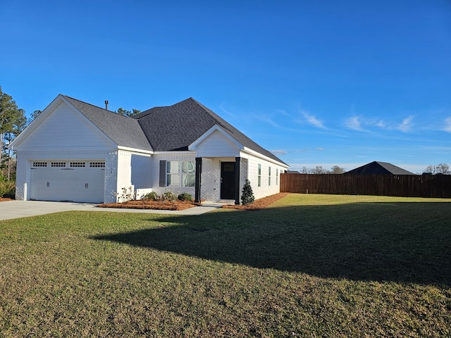 view of front of property featuring a garage and a front yard