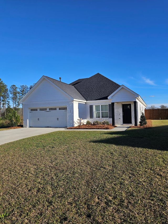 ranch-style house with a garage and a front lawn