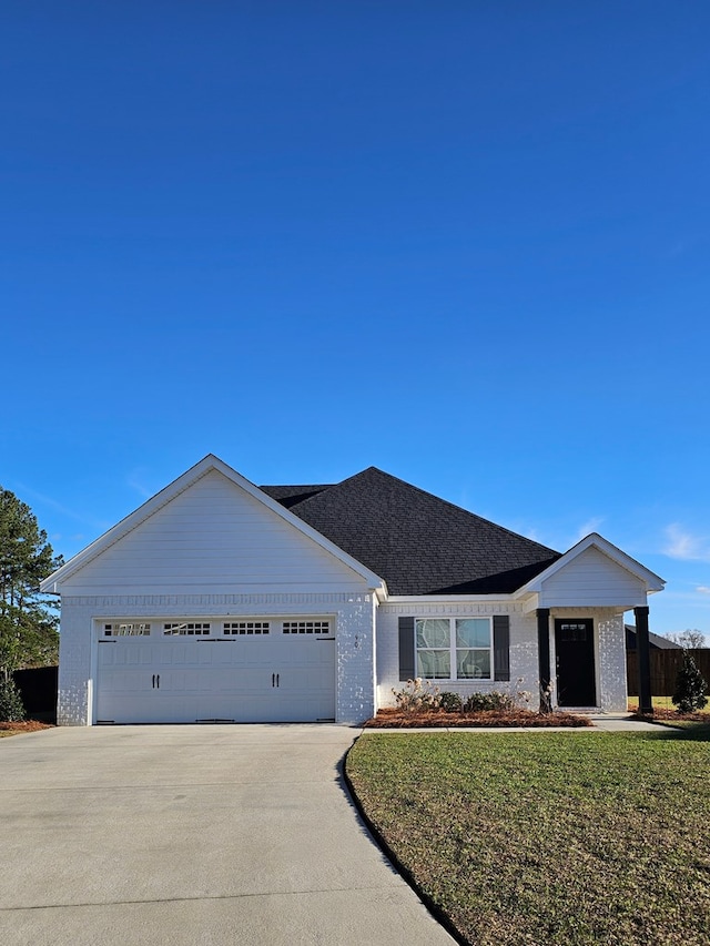 single story home with a garage and a front yard