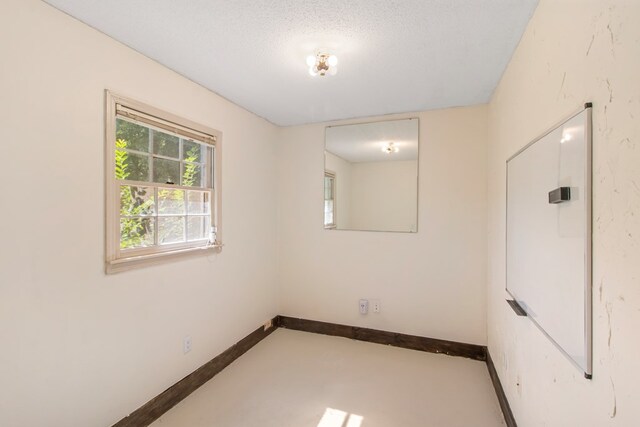 spare room featuring a textured ceiling